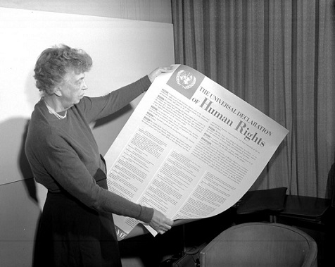Eleanor Roosevelt holds a poster of the Universal Declaration of Human Rights, 1949