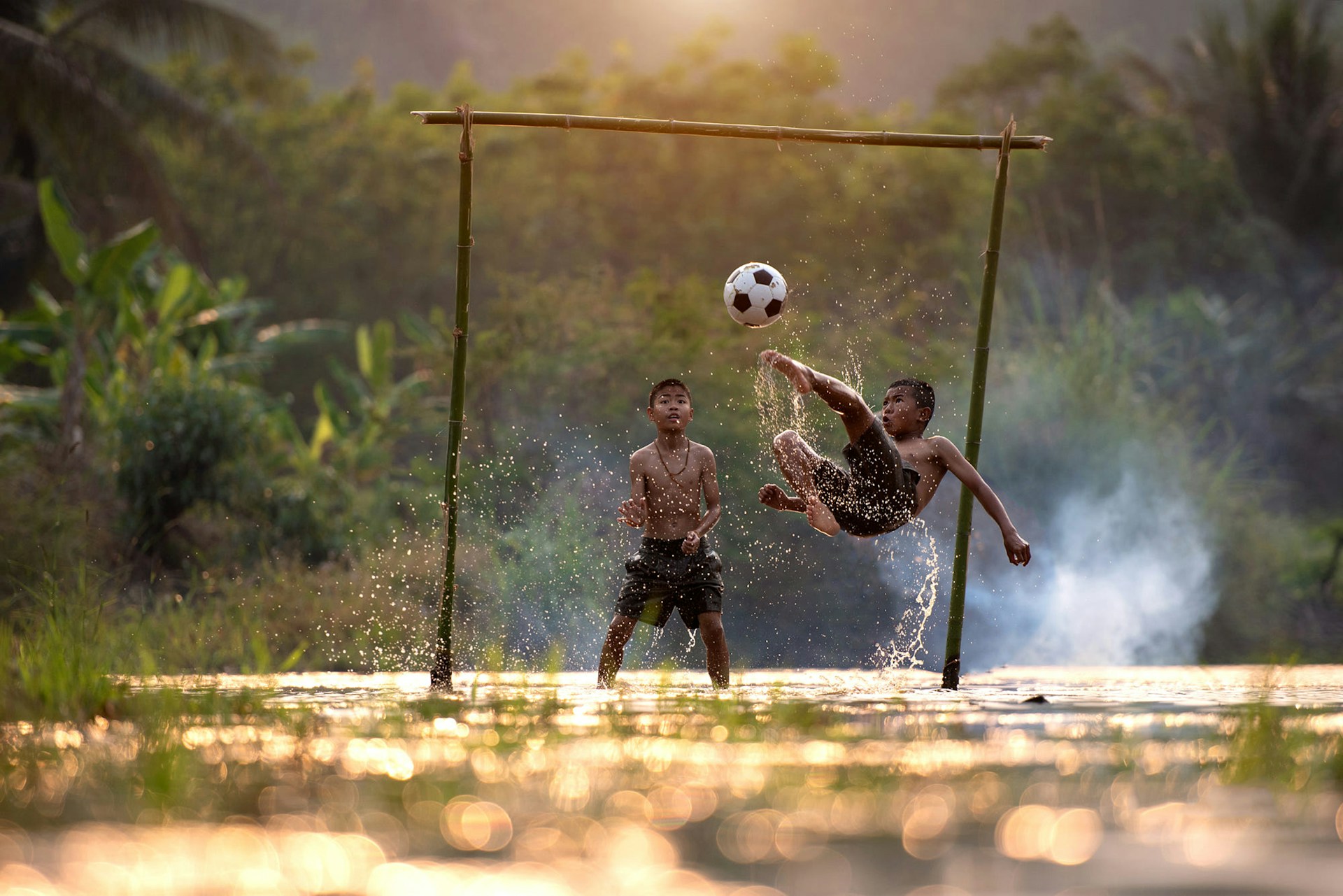 Young people playing soccer together in a community setting